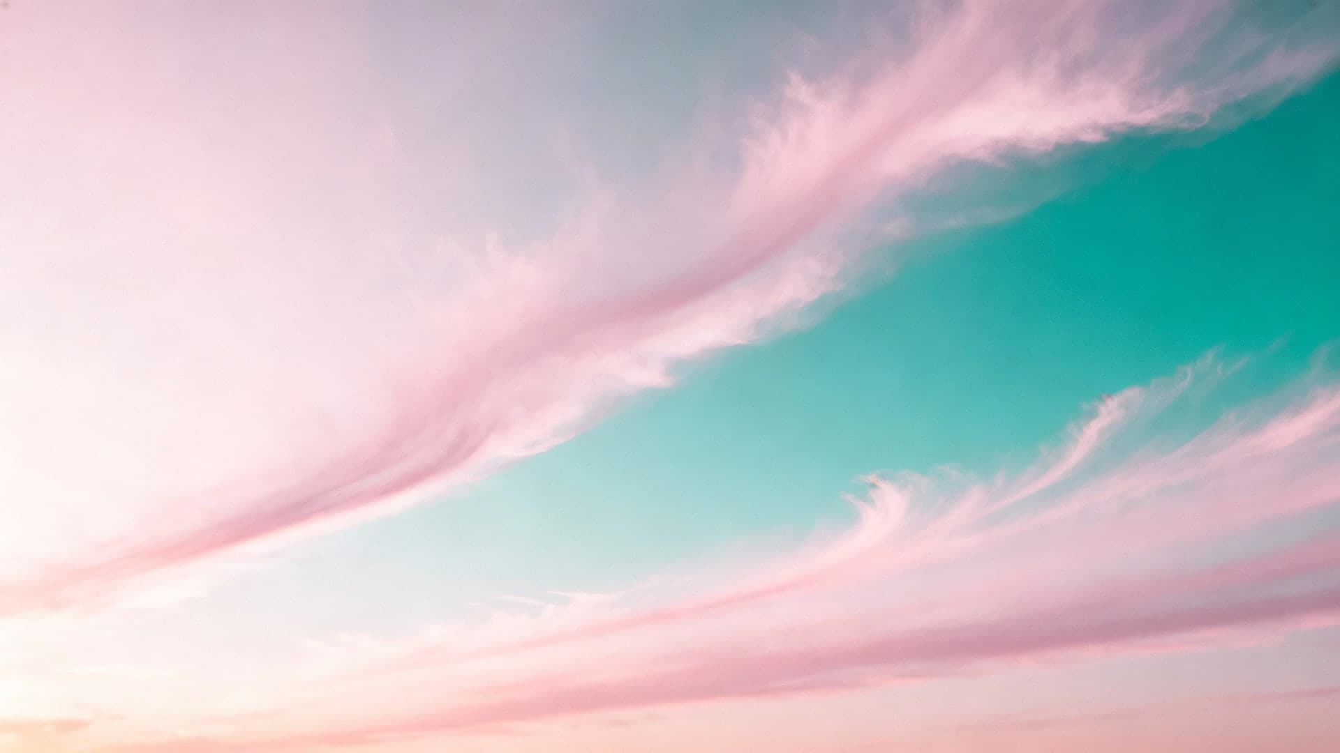soft pink-to-teal pastel gradient sky with wispy clouds
