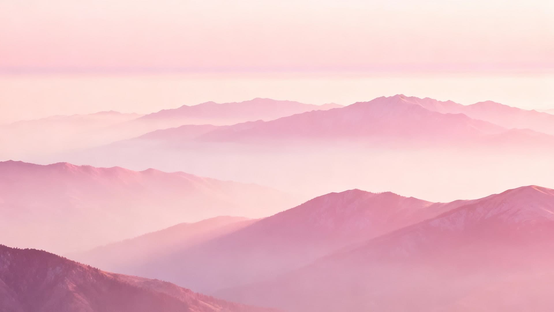 soft misty pink mountains layered in atmospheric depth