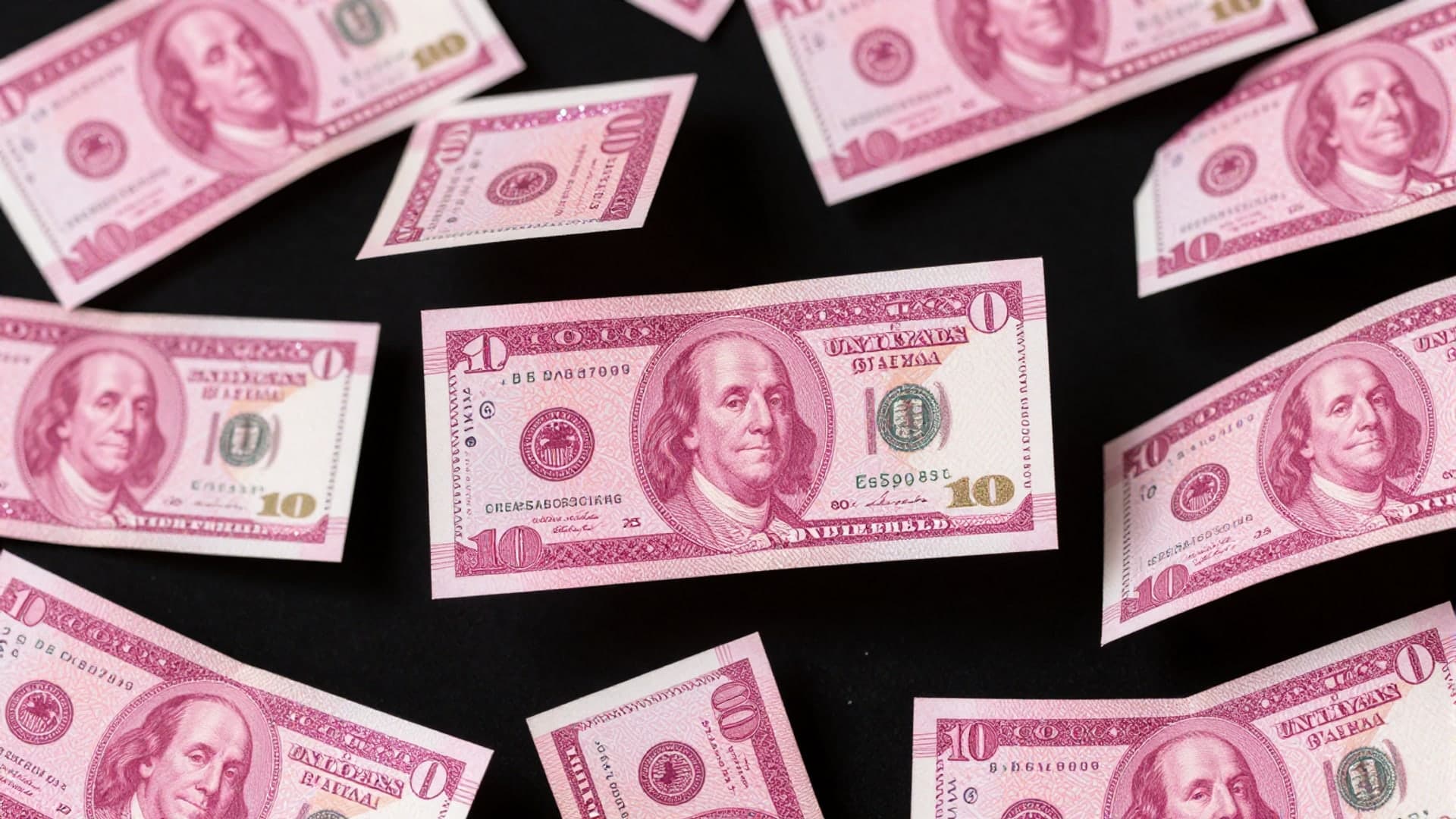 A sparkling pattern of pink glitter banknotes in a glamorous pop aesthetic.