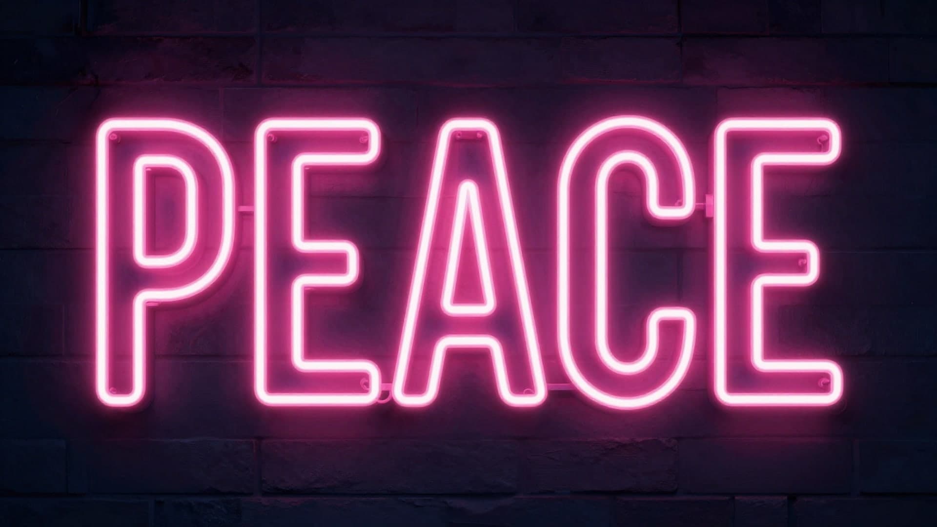 Neon letters forming the word PEACE glowing in pink light.